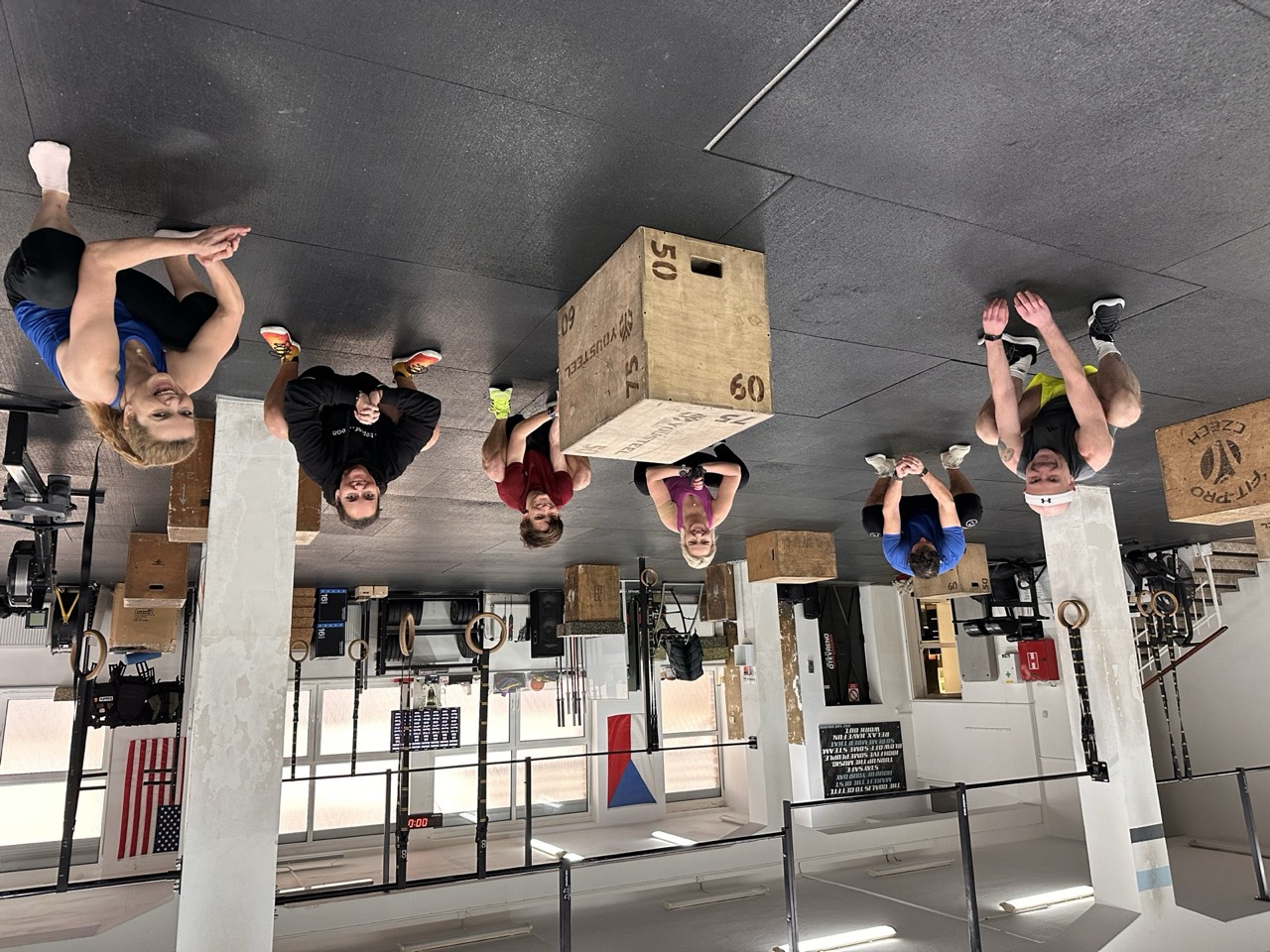 A class laughing and resting between sets on the training floor